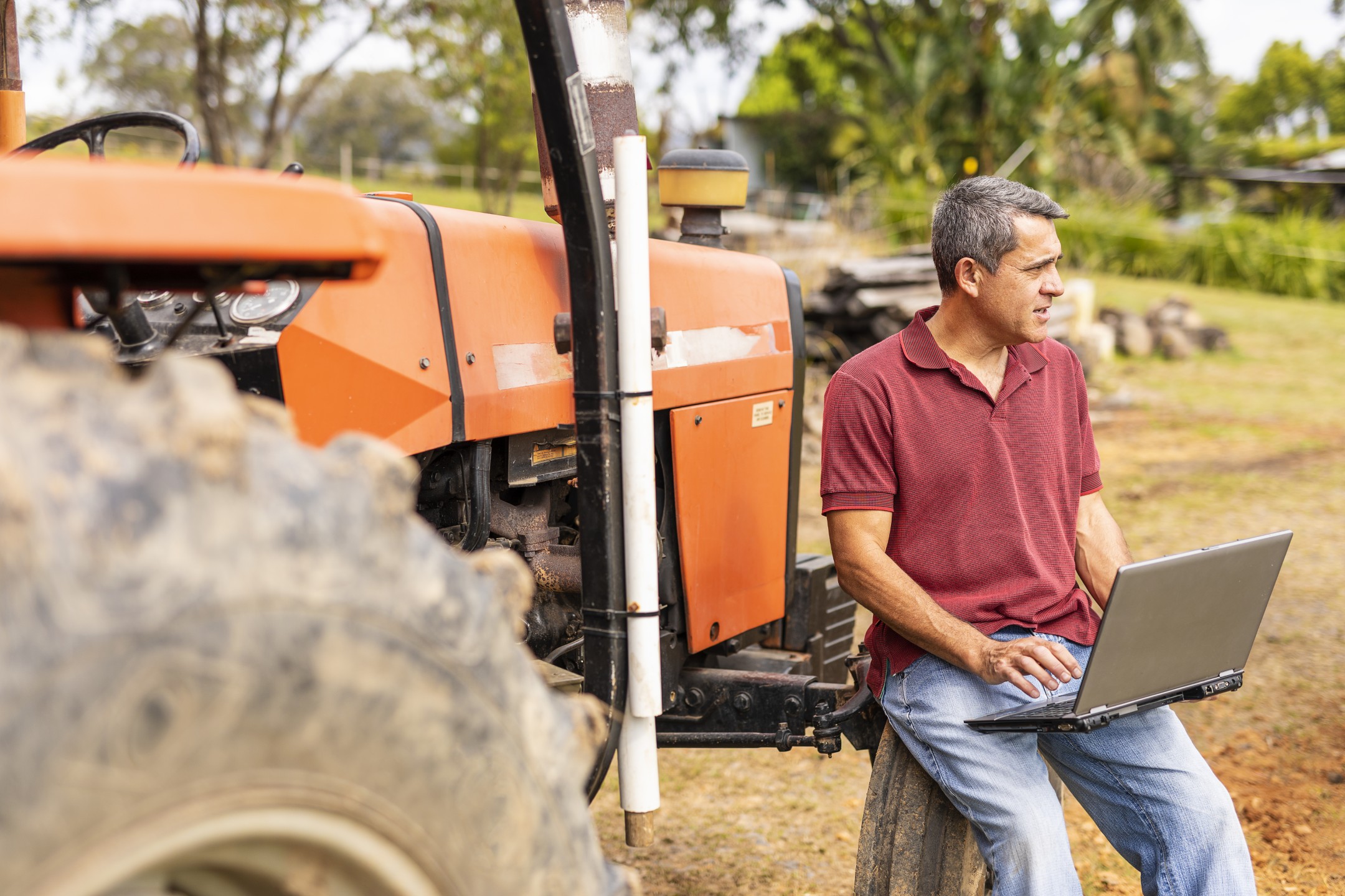 Farmer reviewing data on a laptop